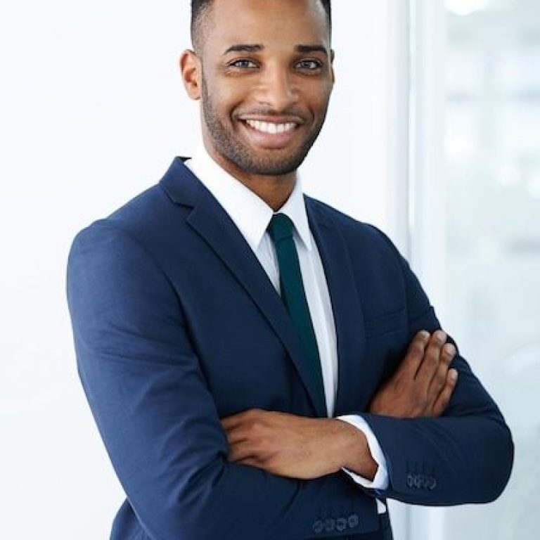 Confident corporate charm a handsome young african american businessman standing indoors with his arms folded _ Premium Photo